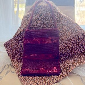 Red sequin bag. 5 1/2 inches wide 7 inches high, 24 inch strap  snap closure